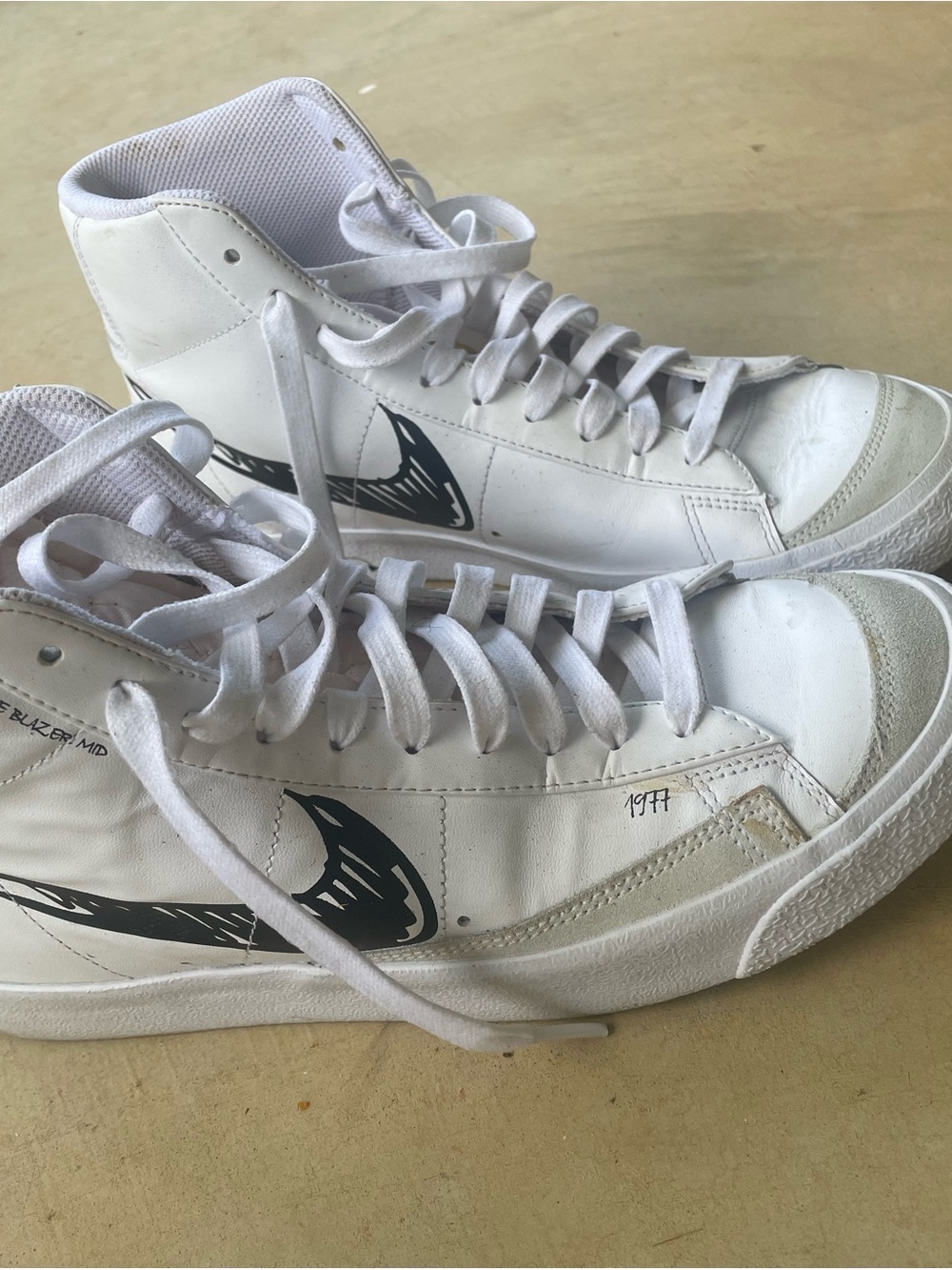 Nike White High-Top Sneakers with Black Swoosh Graphic